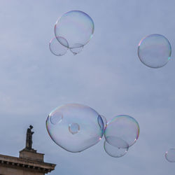 Low angle view of bubbles against sky