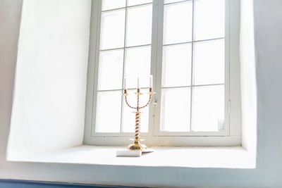 Low angle view of light bulb hanging from ceiling