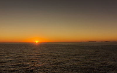 Scenic view of sea against clear sky during sunset