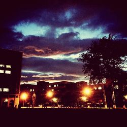 View of illuminated buildings at sunset