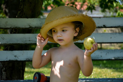 Portrait of shirtless boy wearing hat