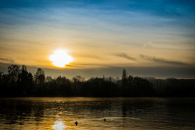 Scenic view of lake against sky during sunset