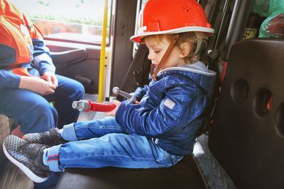 Close-up of boy sitting in fire truck