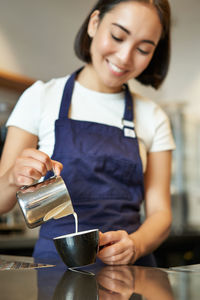 Portrait of young woman using mobile phone