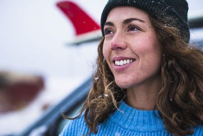 Woman surfer portrait with frozen surfboard