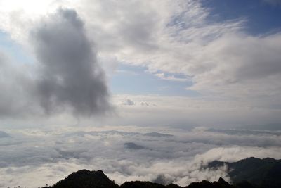 Low angle view of clouds over mountain