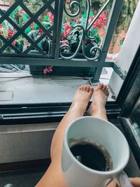 Midsection of woman holding coffee cup