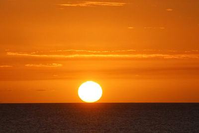 Scenic view of sea against romantic sky at sunset