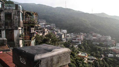 Buildings against mountain range and clear sky