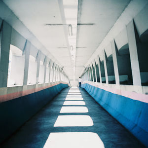 Man walking in corridor of building