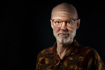 Portrait of man against black background