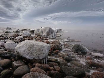 Scenic view of rocks in water against sky