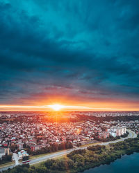 High angle view of illuminated buildings against sky at sunset