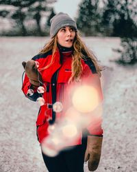 Portrait of woman standing in snow