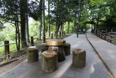 Wooden stools and table arranged at footpath in jeju jeolmul recreational forest