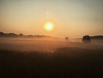 Scenic view of field against sky during sunset