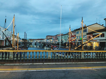 View of bridge over river in city against sky