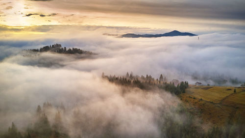 Alpine village. autumn rural landscape. cold november morning. morning fog in mountain valley. 