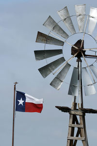 Low angle view of flags against sky