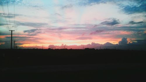 Silhouette landscape against sunset