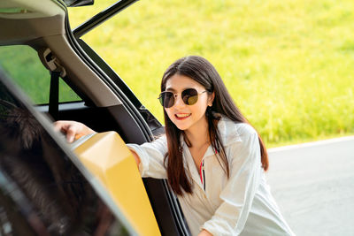 Portrait of smiling young woman in car