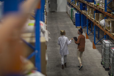 Two women walking in warehouse
