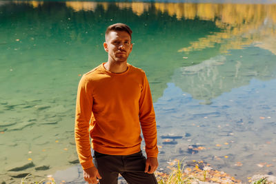 Portrait of young woman standing in lake