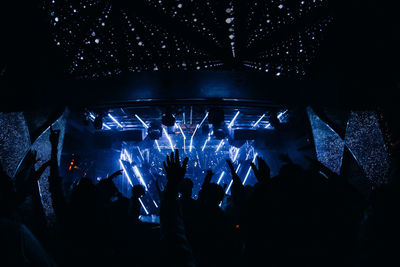 Group of silhouette people at music concert