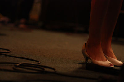 Low section of woman standing on rug