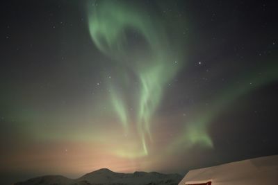 Scenic view of mountains against sky at night