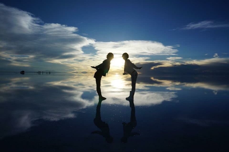 SILHOUETTE OF GIRL STANDING IN WATER