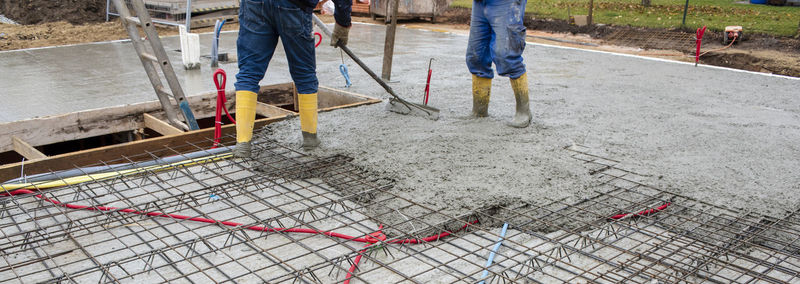 New house in construction with worker and concrete