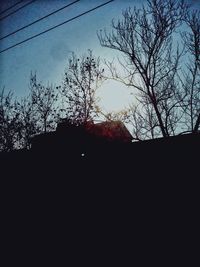 Low angle view of bare trees against sky