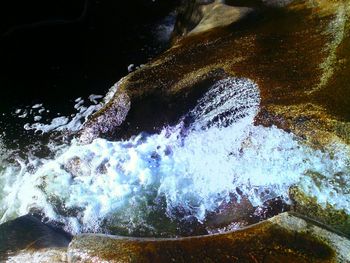 View of water flowing through rocks