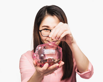 Close-up of a woman hand holding glass over white background