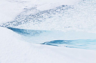 Close-up of snow on sea shore