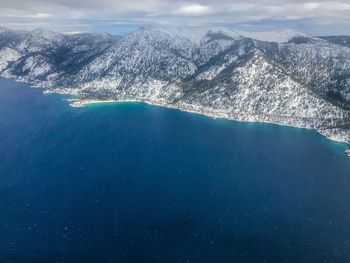 Aerial view of sea and mountains against sky