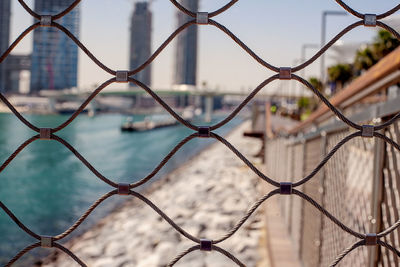 Dubai, uae, april 2019 blurred view of the city through a metal mesh closeup