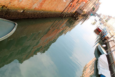 Reflection of boat in sea against sky