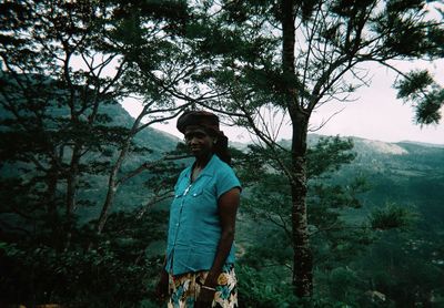 Full length of young man standing on tree