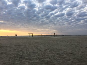 Scenic view of beach against sky during sunset