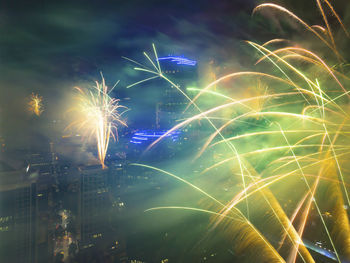 Low angle view of firework display at night