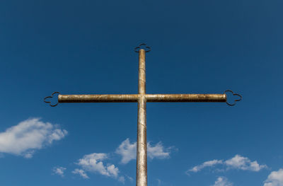 Low angle view of street light against blue sky