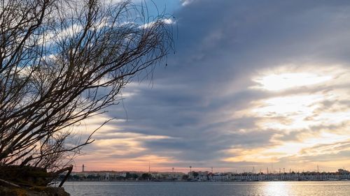 Scenic view of river against sky at sunset