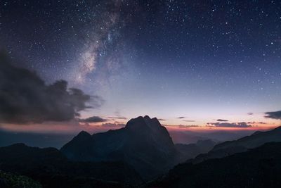 Scenic view of mountains against sky at night