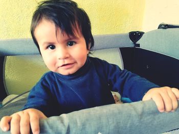 Portrait of cute boy sitting at home