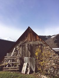 Built structure by mountain against sky