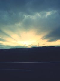 Silhouette landscape against sky at sunset