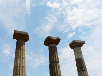 Ruins of ancient columns aginst the blue sky
