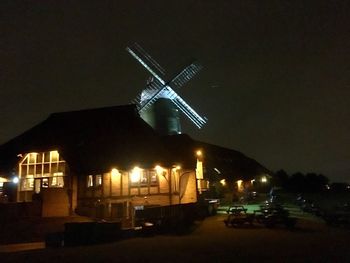 Traditional windmill against sky at night